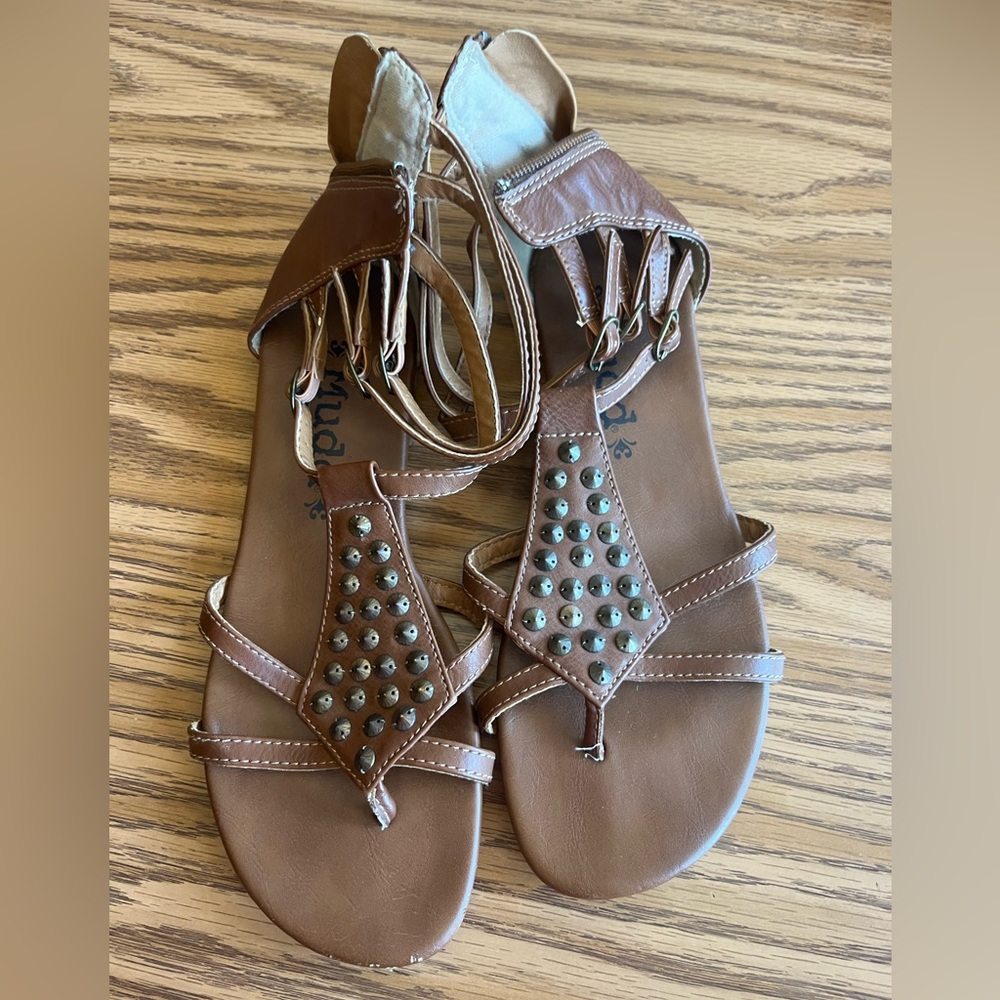 These sandals are brown and size 7.5.